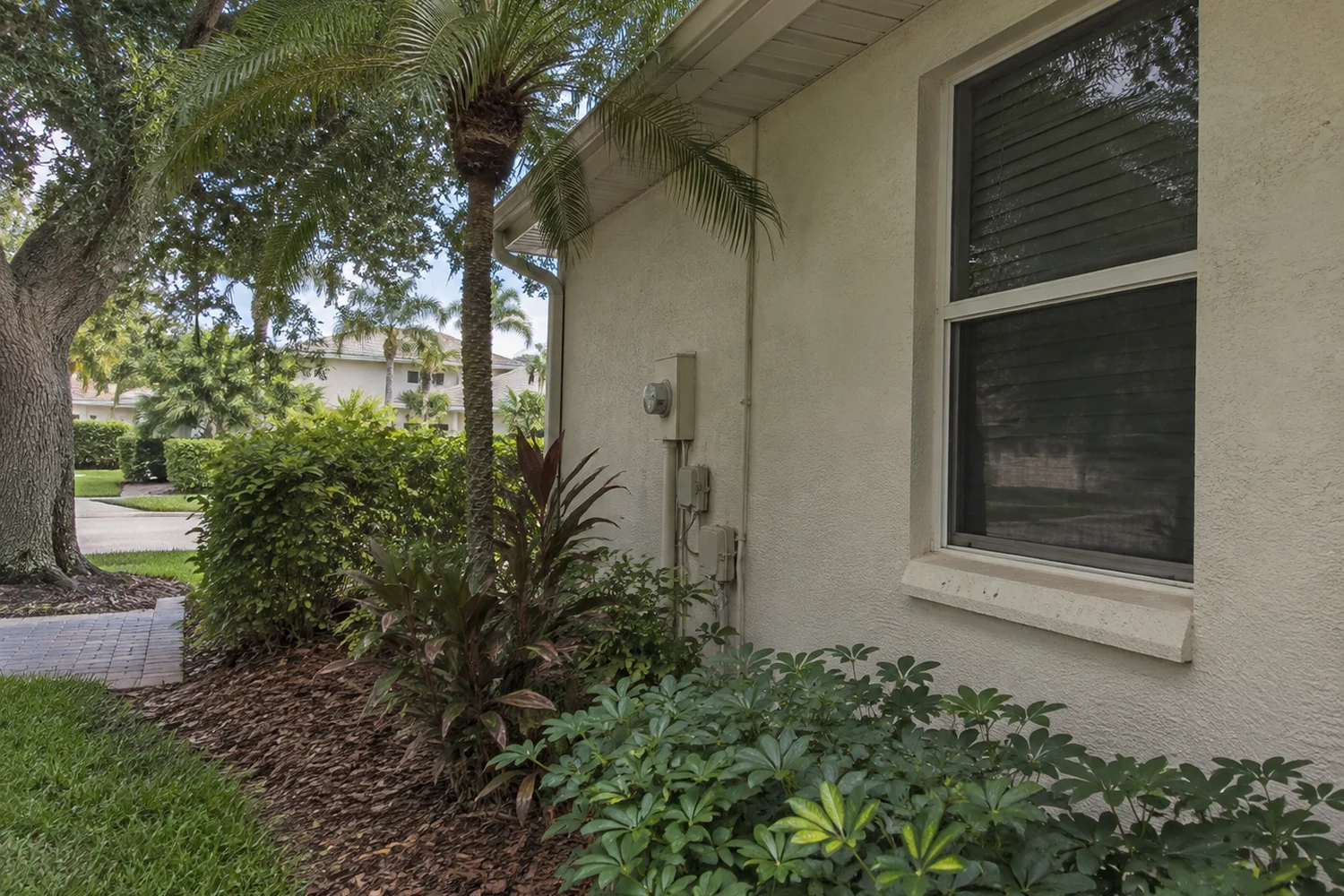 Fort Myers residential window and stucco exterior in a shaded home setting