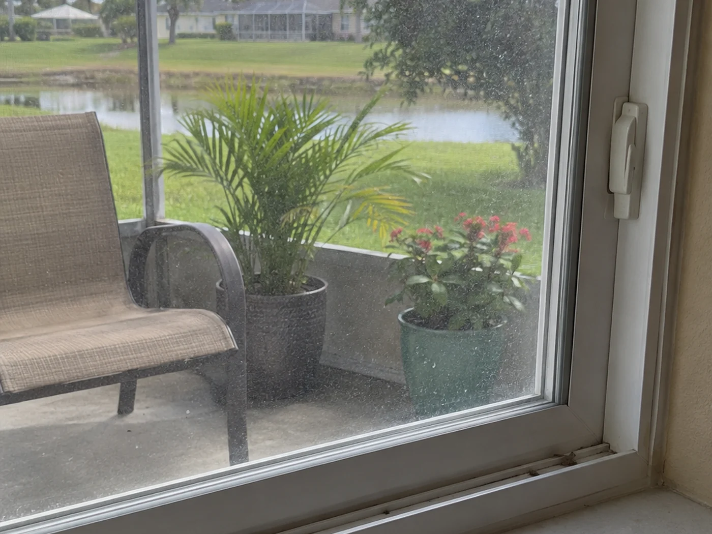 Residential window with visible ordinary film and water marks before cleaning